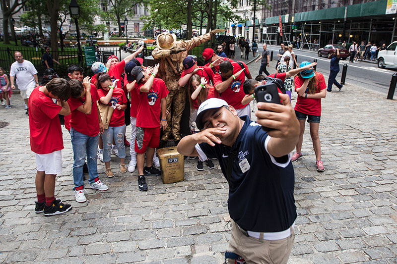 A School Tours of America New York City Guide is talking to students in Central Park during the Fall.