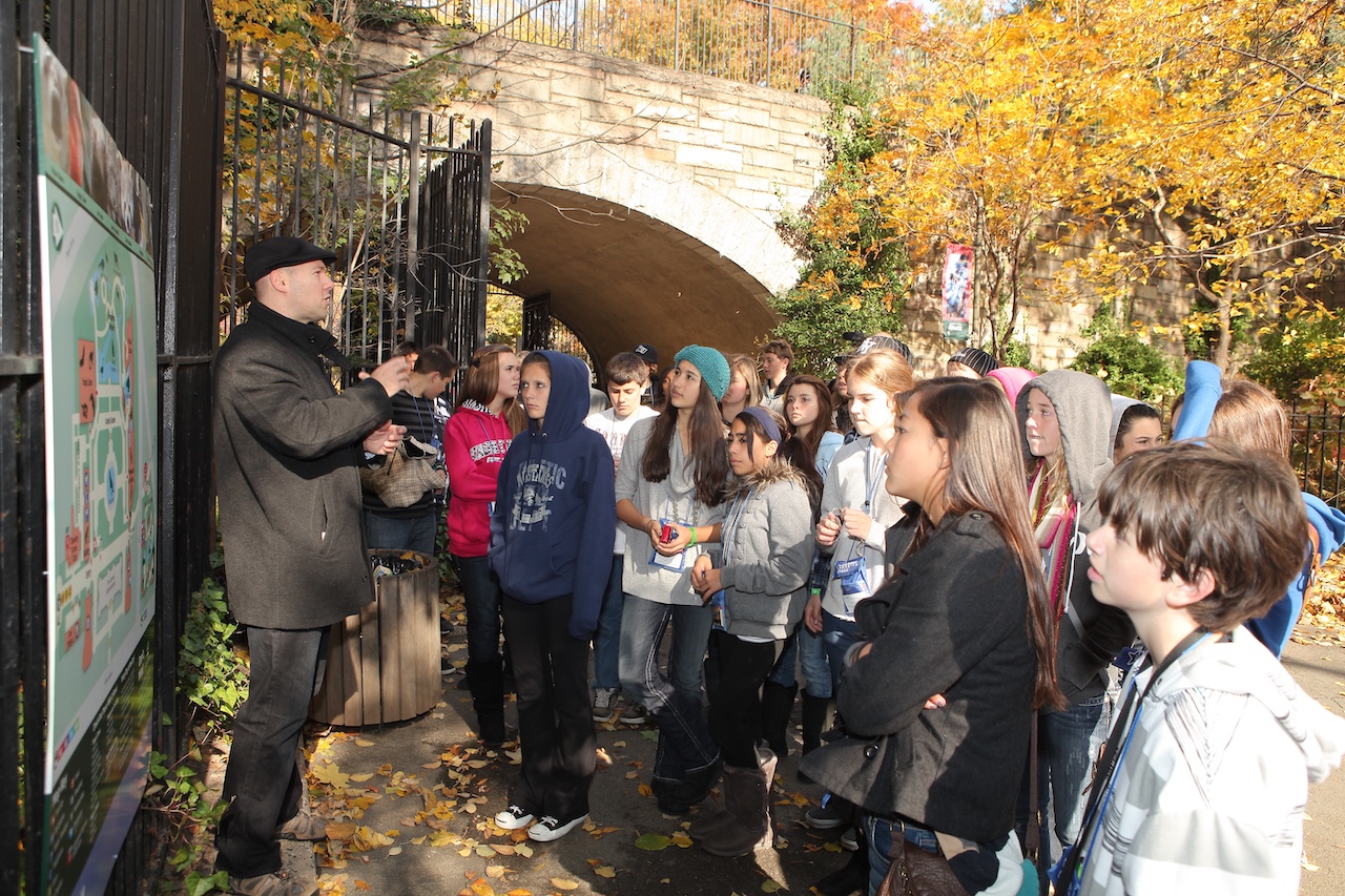 A School Tours of America New York City Guide is talking to students in Central Park during the Fall.